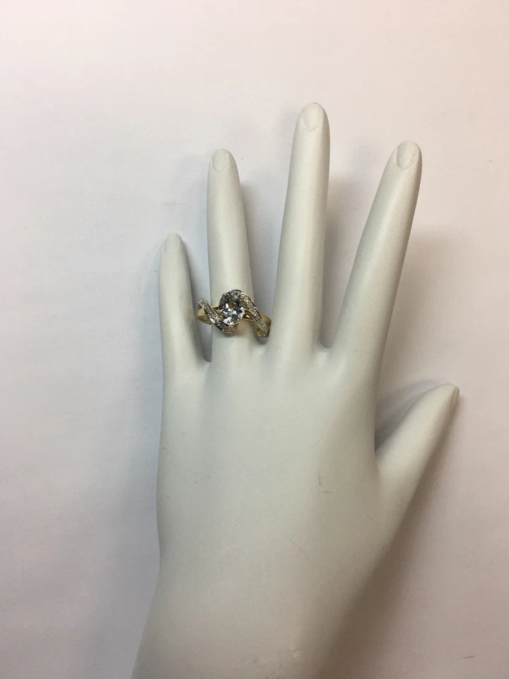 Modern Gold Natural .10 Carat Diamond and Oval Blue Aquamarine Cocktail Ring