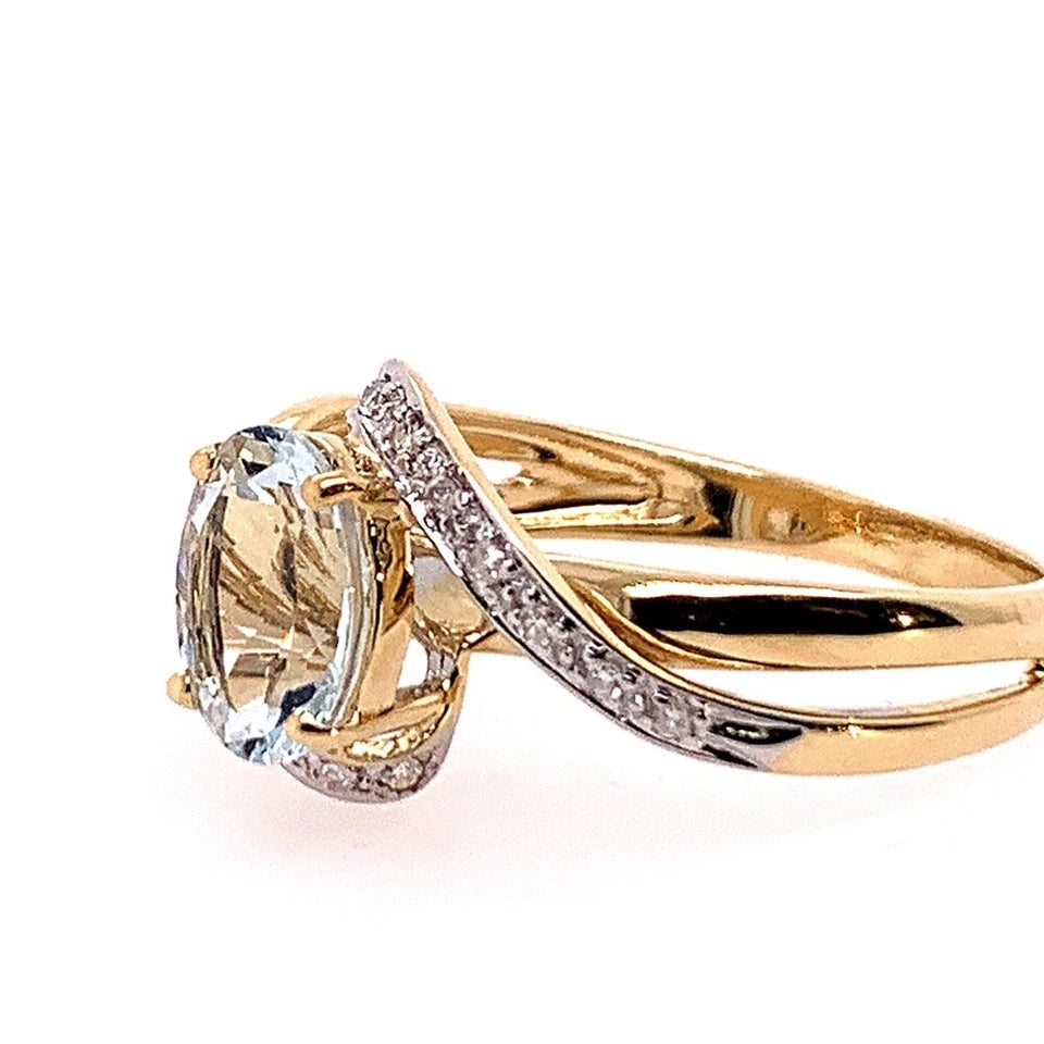 Modern Gold Natural .10 Carat Diamond and Oval Blue Aquamarine Cocktail Ring