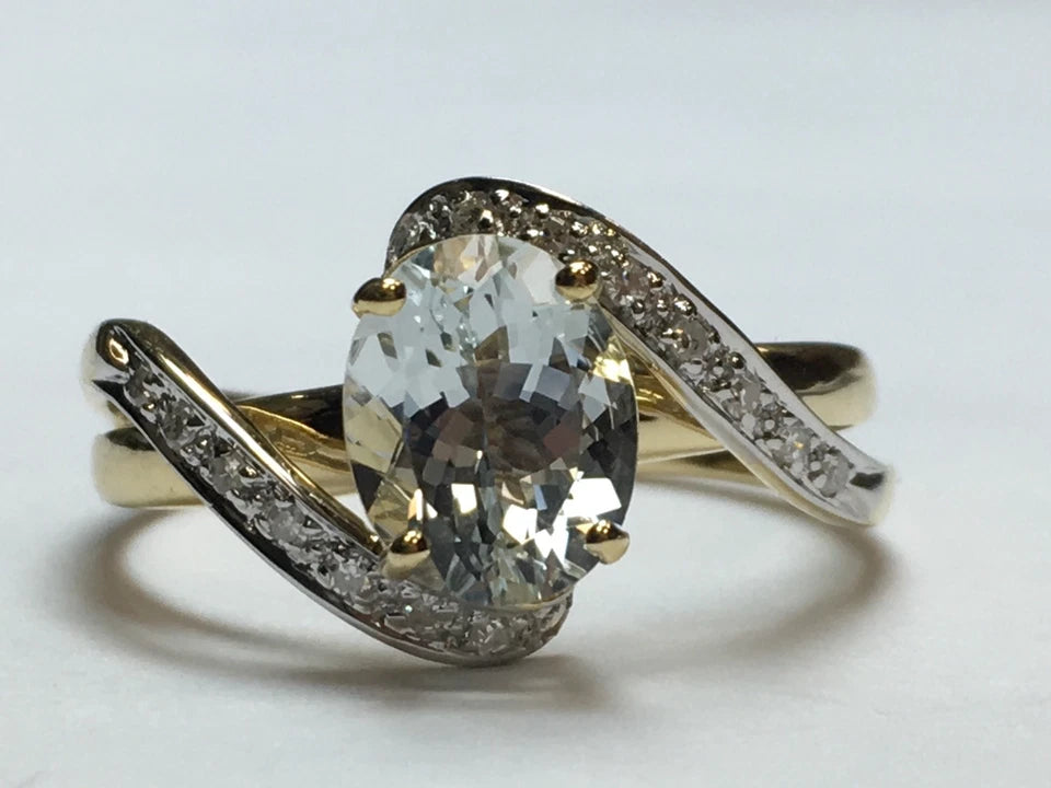 Modern Gold Natural .10 Carat Diamond and Oval Blue Aquamarine Cocktail Ring