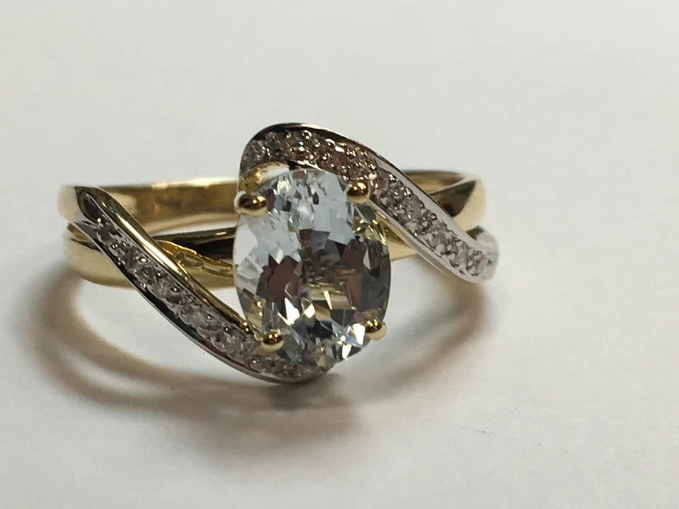 Modern Gold Natural .10 Carat Diamond and Oval Blue Aquamarine Cocktail Ring